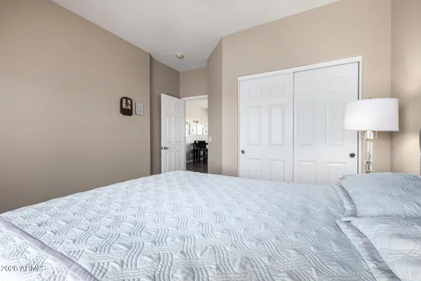 a bedroom with a bed and a lamp