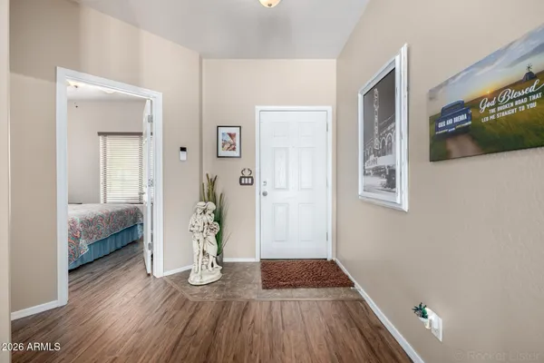 a view of a livingroom with wooden floor and a bedroom