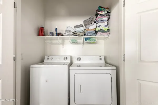 a view of storage and utility room with washer and dryer