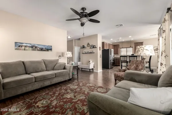 a living room with furniture and a view of kitchen