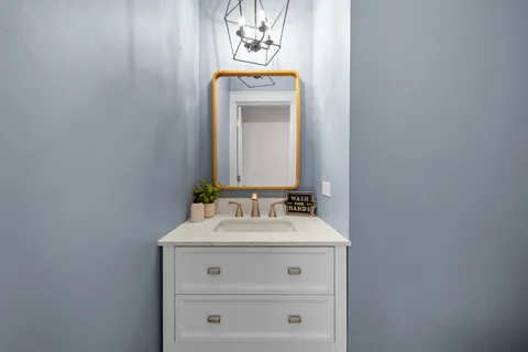 a bathroom with a sink vanity and mirror