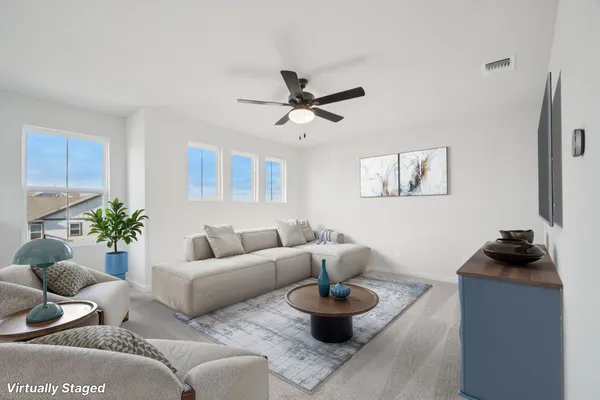 a living room with furniture and a chandelier