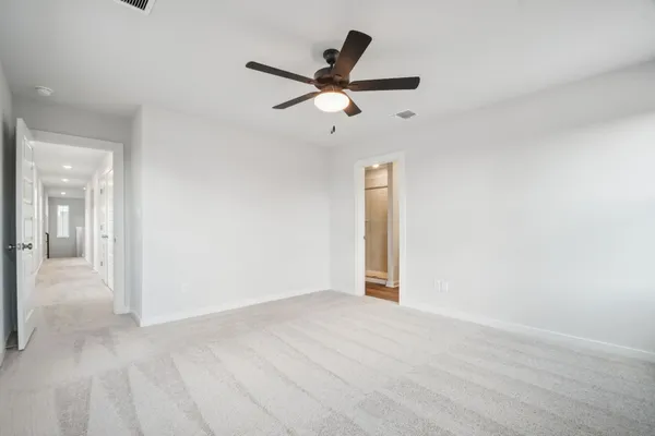a view of a livingroom with a ceiling fan and window