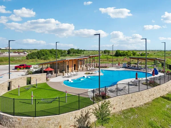 a view of a swimming pool with lawn chairs