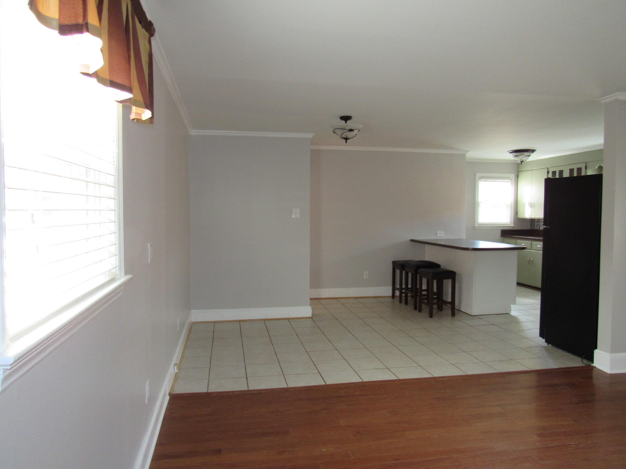 4413 Hazelridge Road Northwest Roanoke, VA 24012 - Photo 13 of 23 an empty room with wooden floor and a way to kitchen