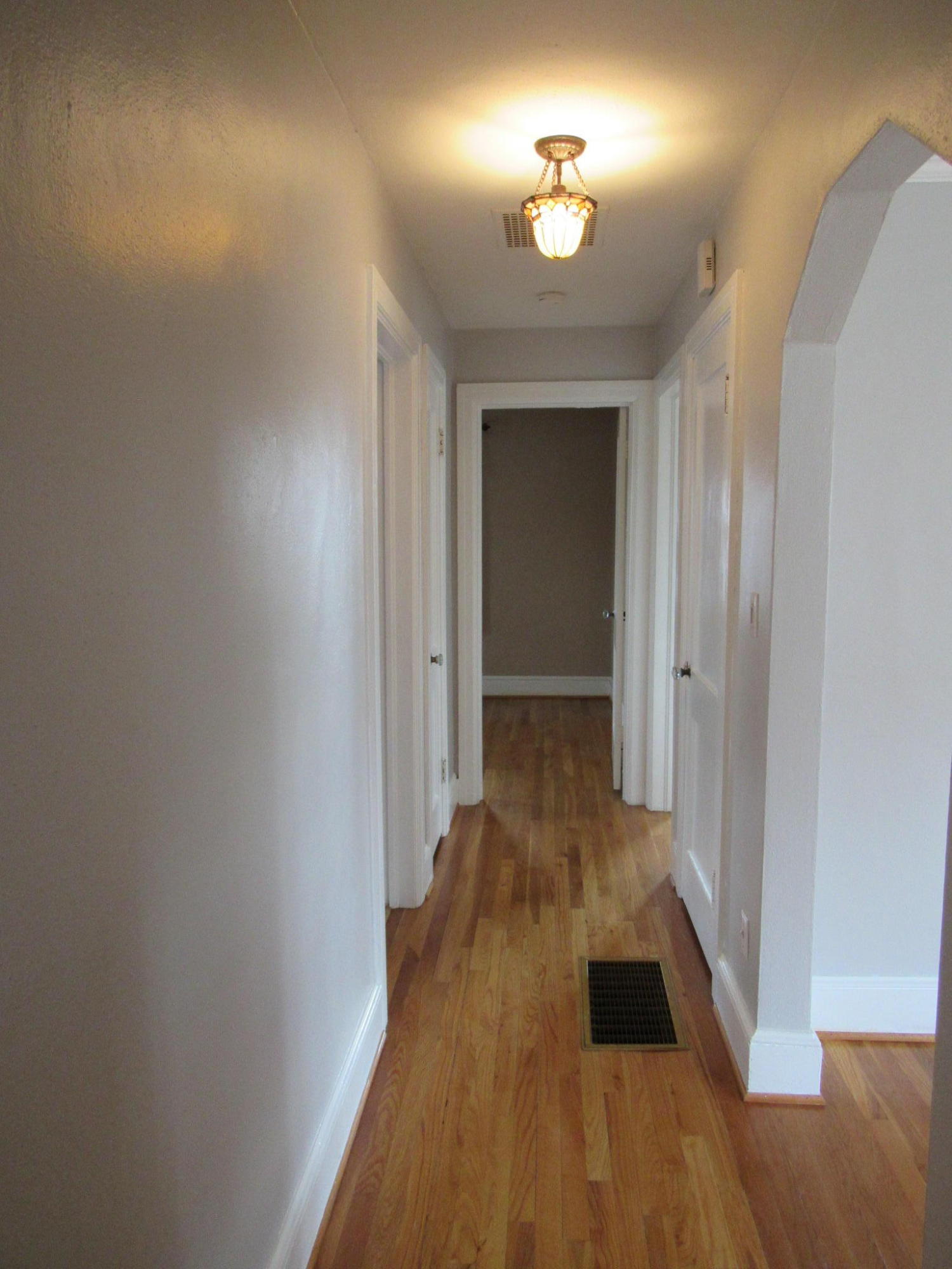 4413 Hazelridge Road Northwest Roanoke, VA 24012 - Photo 16 of 23 a view of a hallway with wooden floor and a chandelier