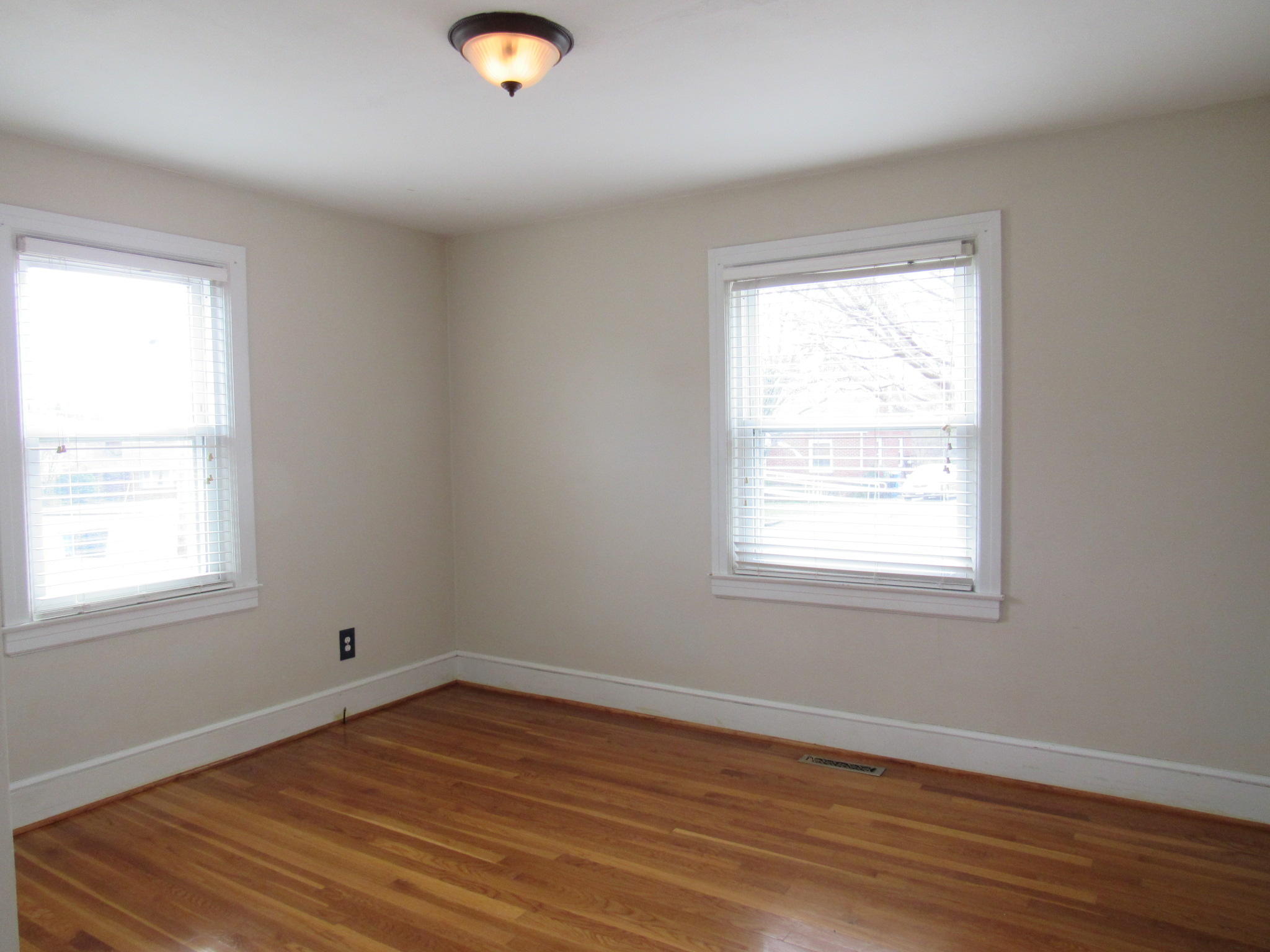 4413 Hazelridge Road Northwest Roanoke, VA 24012 - Photo 17 of 23 an empty room with wooden floor and windows