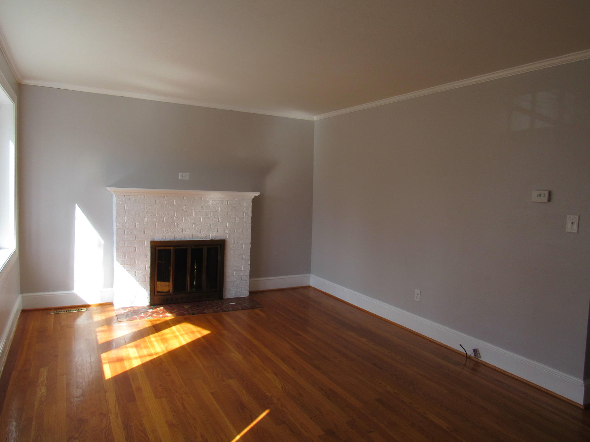 4413 Hazelridge Road Northwest Roanoke, VA 24012 - Photo 6 of 23 a view of empty room with wooden floor and fireplace