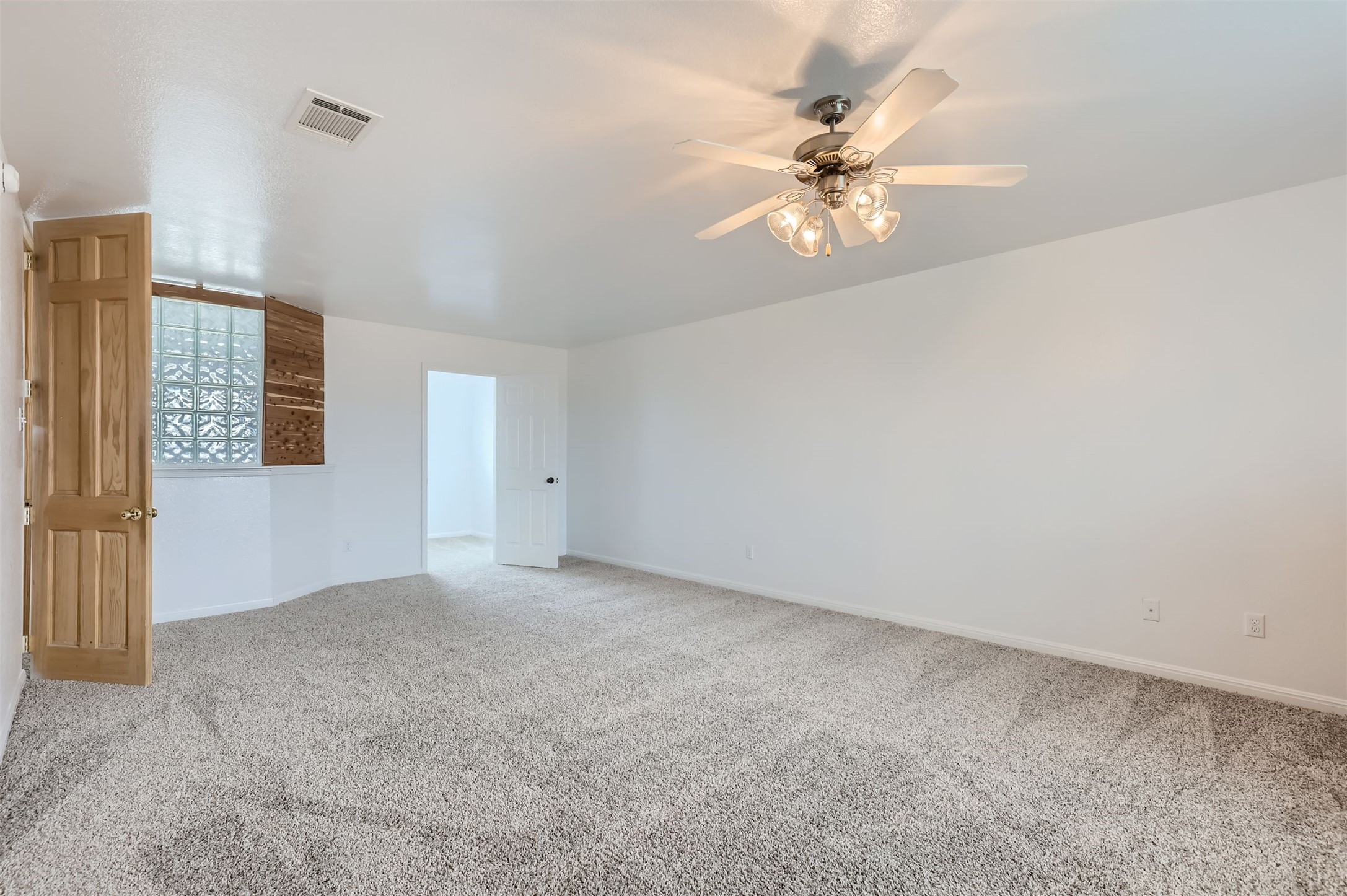 131 Lavaca Loop Hutto, TX 78634 - Photo 16 of 29 A quiet retreat with plush carpeting and a modern ceiling fan for ultimate comfort.