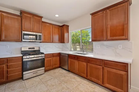 a kitchen with stainless steel appliances granite countertop a sink and cabinets