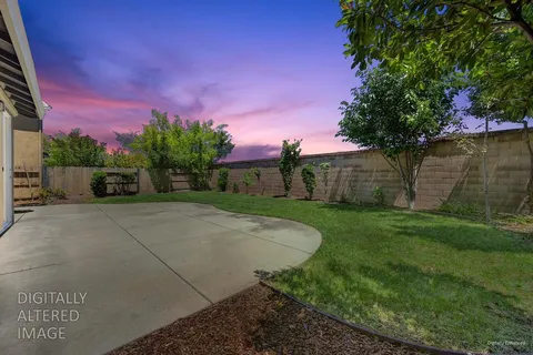 a view of a yard with a house in the background