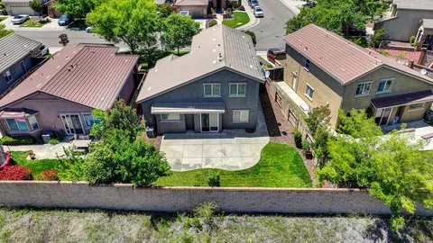 an aerial view of a house with plants and large trees