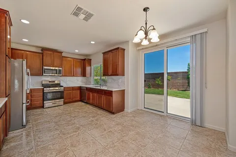 a large kitchen with stainless steel appliances lots of counter top space