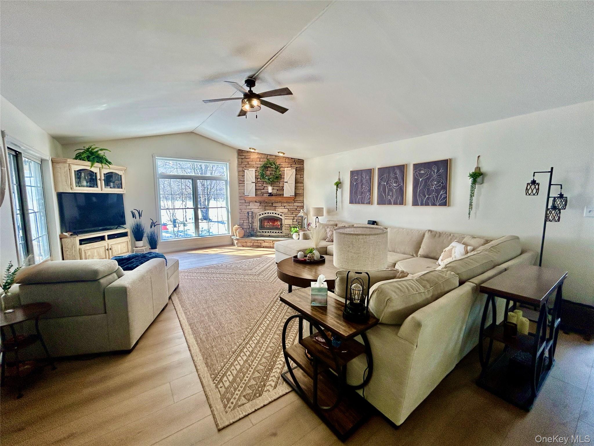 290 Gulf Road Roscoe, NY 12776 - Photo 14 of 30 Living room featuring wood finished floors, a fireplace, and ceiling fan