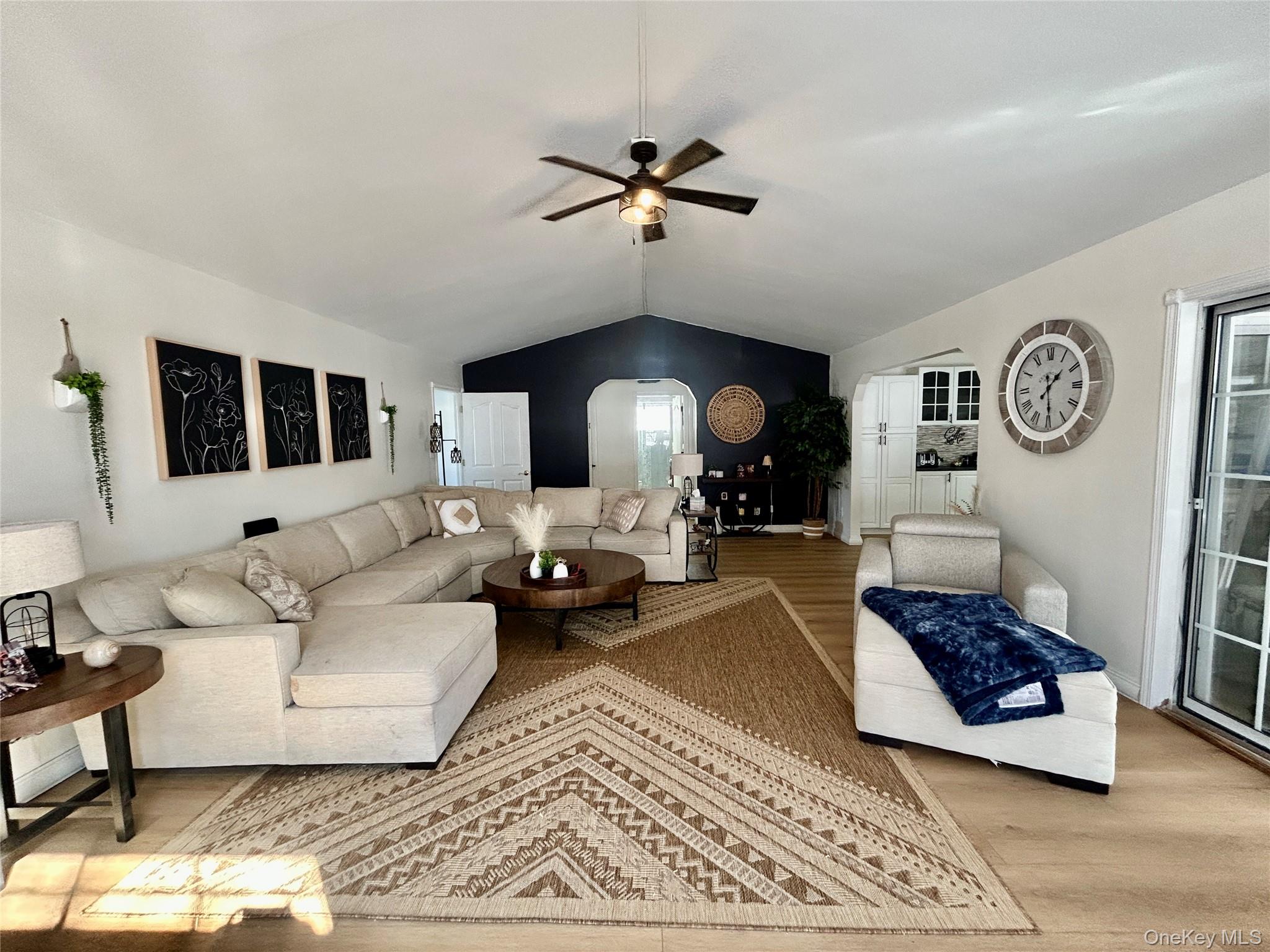 290 Gulf Road Roscoe, NY 12776 - Photo 10 of 26 Living room featuring arched walkways, ceiling fan, and wood finished floors