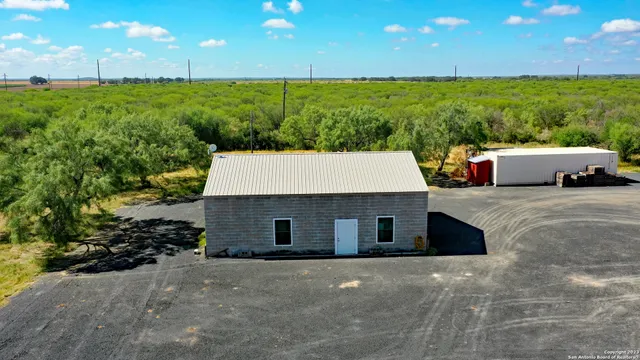 an aerial view of a house with a yard
