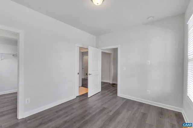a view of an empty room and wooden floor
