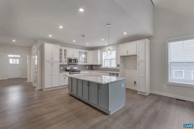 a kitchen with stainless steel appliances granite countertop a stove and a refrigerator