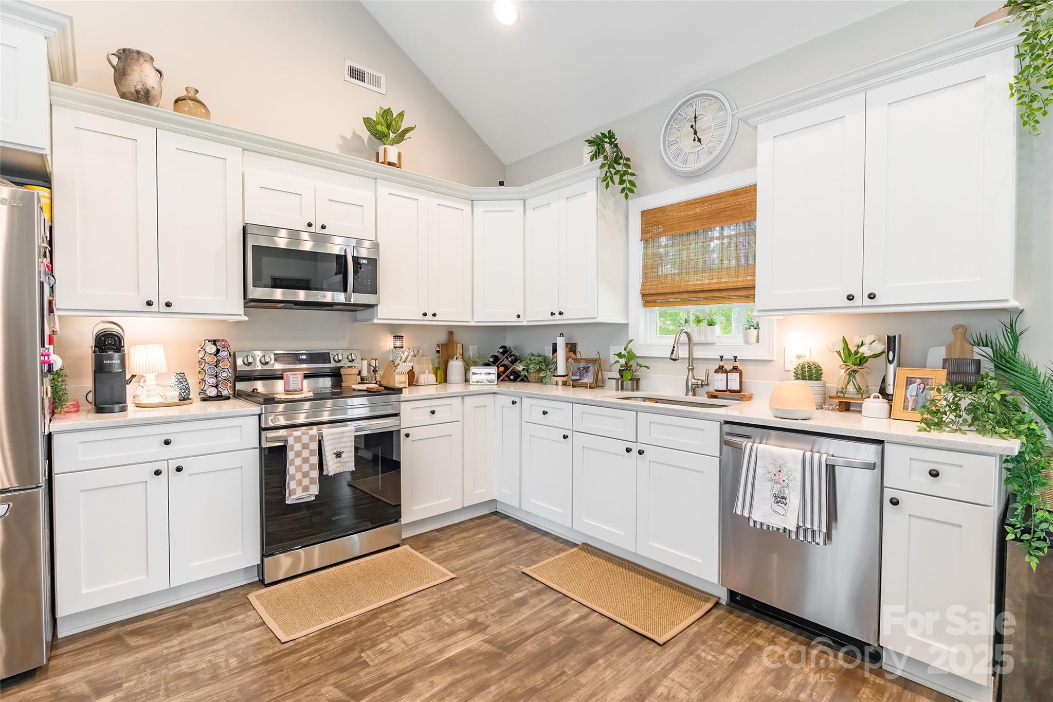 137 Ole Eastpointe Drive York, SC 29745 - Photo 12 of 28 a kitchen with stainless steel appliances granite countertop a stove a sink and a white cabinets