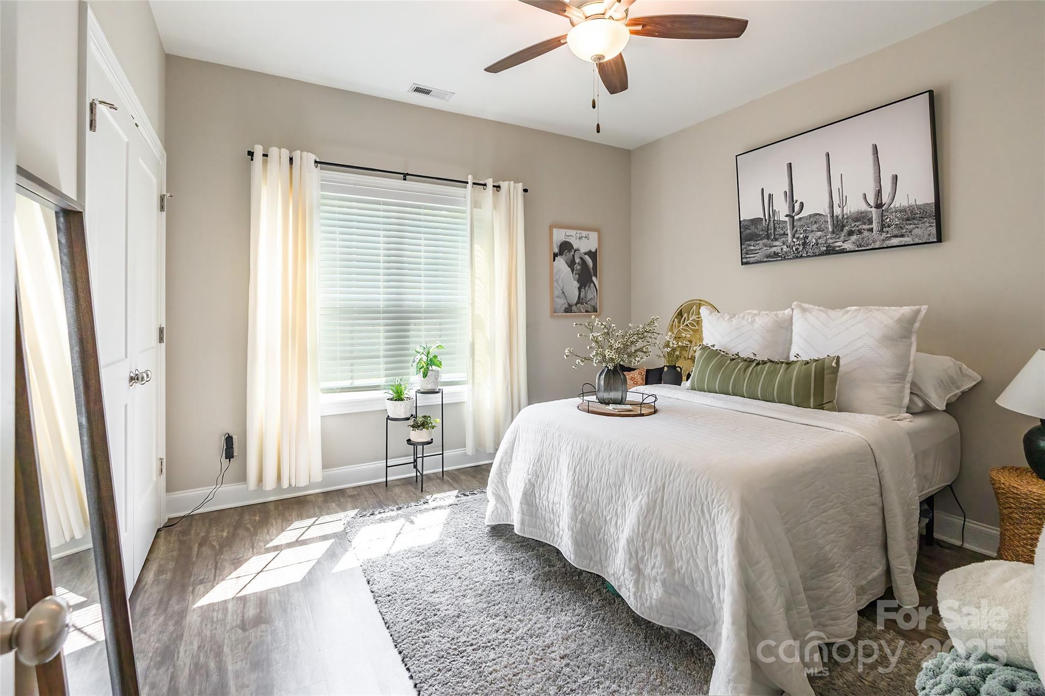 137 Ole Eastpointe Drive York, SC 29745 - Photo 17 of 28 a bedroom with a large bed and a chandelier