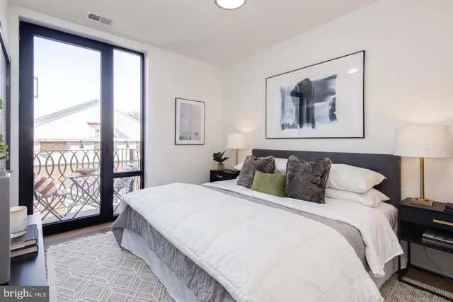 a bedroom with a large bed and a large window