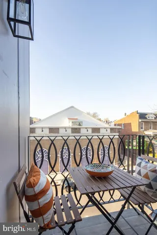 a view of a dinning room with rug and wooden floor