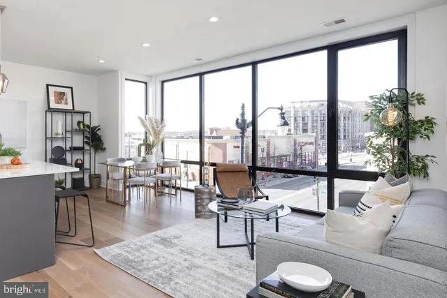 a living room with furniture and a floor to ceiling window