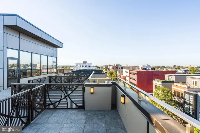 an outdoor view of a balcony with furniture