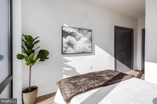 a bedroom that has a bed and a potted plant