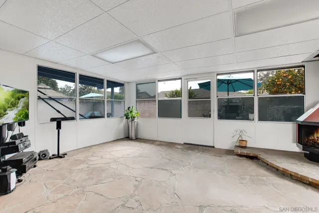 a view of a patio with furniture and a umbrella