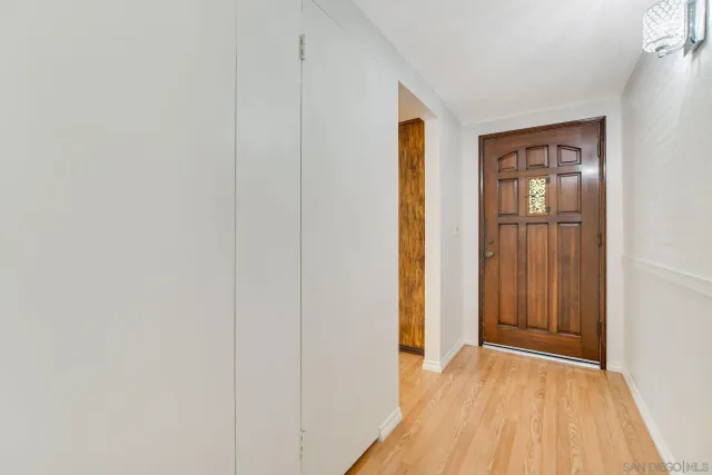 a living room with furniture wooden floor and a window