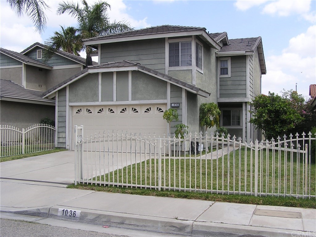 1036 North Jacaranda Road Colton, CA 92324 - Photo 1 of 1 a front view of a house with a small garden