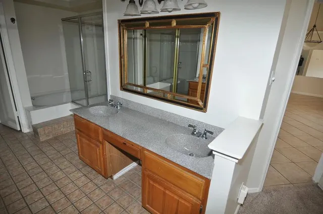 a bathroom with a glass shower door