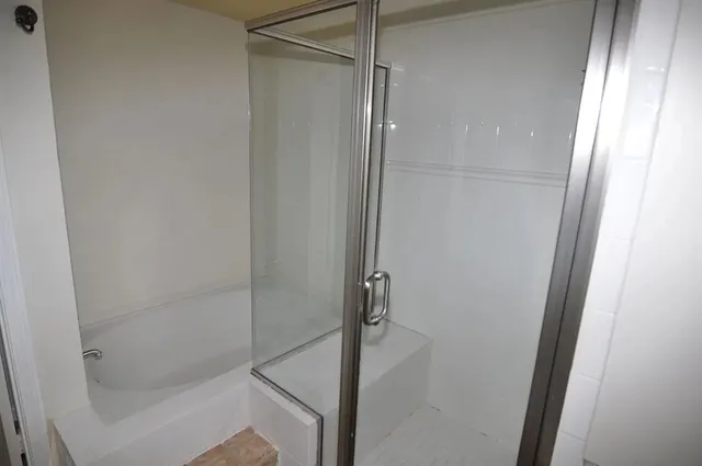 a bathroom with a glass shower door
