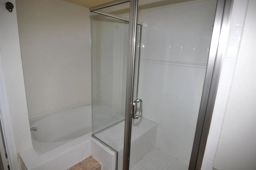 4242 North Capistrano Drive, Unit 118 Dallas, TX 75287 - Photo 11 of 25 a bathroom with a glass shower door