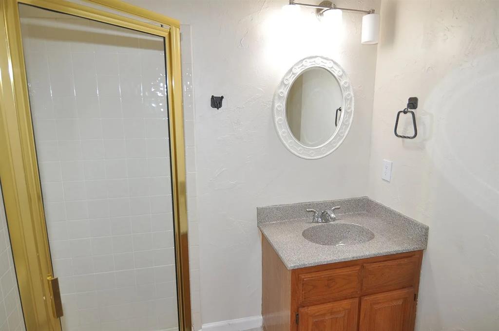 4242 North Capistrano Drive, Unit 118 Dallas, TX 75287 - Photo 13 of 25 a bathroom with a sink and a mirror