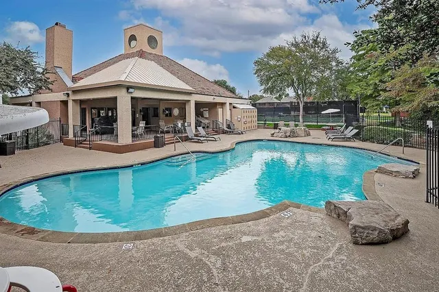 a view of a house with swimming pool and sitting area