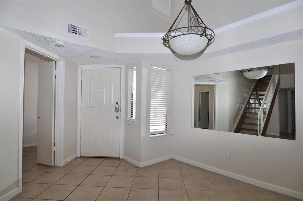 4242 North Capistrano Drive, Unit 118 Dallas, TX 75287 - Photo 2 of 25 a view of a hallway with two windows and chandelier in a room