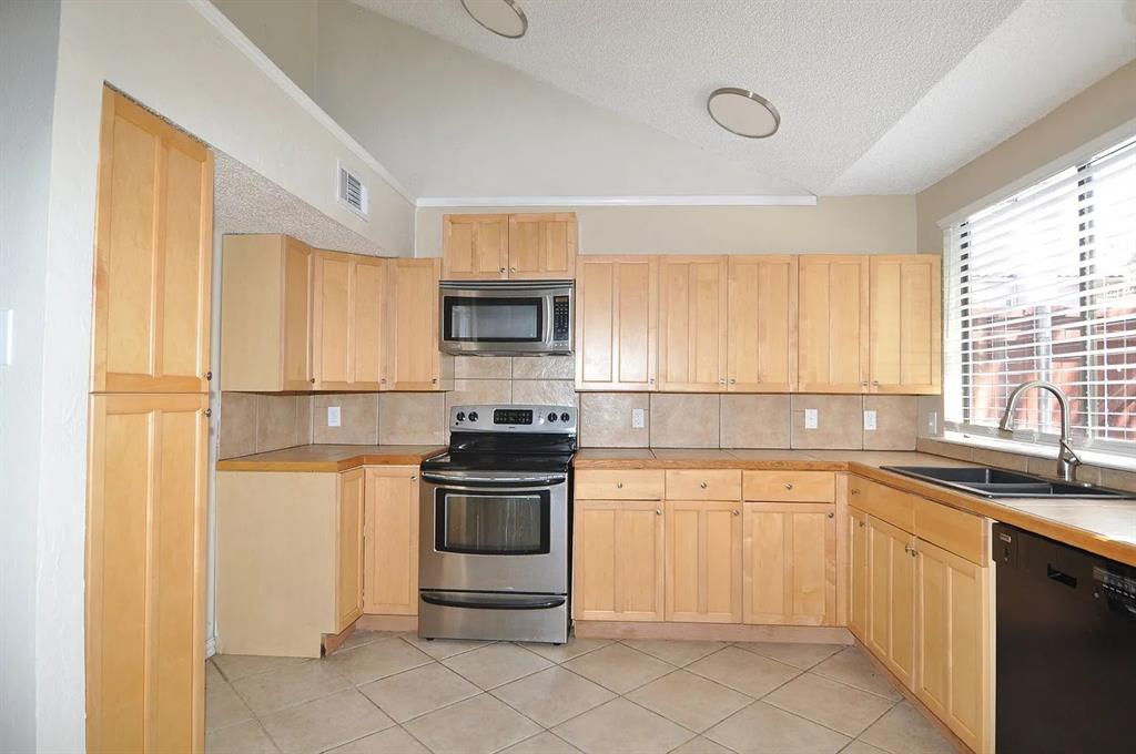 4242 North Capistrano Drive, Unit 118 Dallas, TX 75287 - Photo 5 of 25 a kitchen with a sink stove and microwave