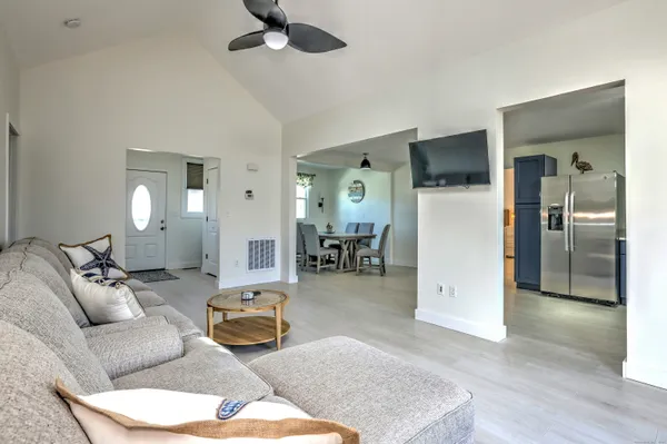 a living room with furniture and a wooden floor