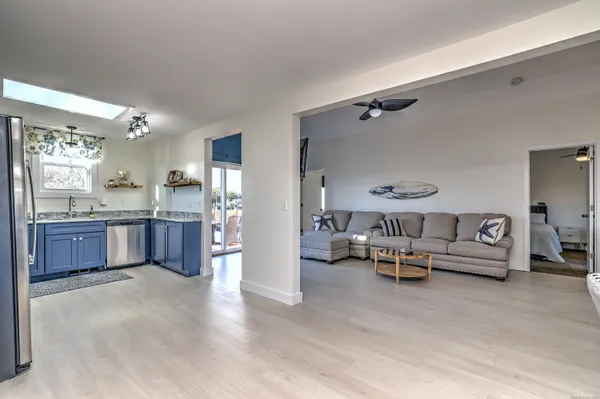 a living room with furniture and kitchen view