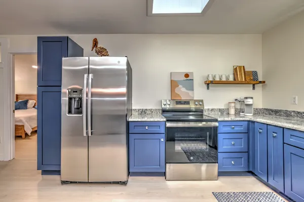 a kitchen with stainless steel appliances granite countertop a refrigerator and a stove