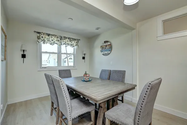 a view of a dining room with furniture and window