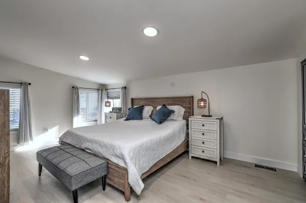 a bedroom with a bed and a night stand