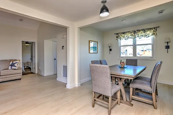 a view of a dining room with furniture and a window