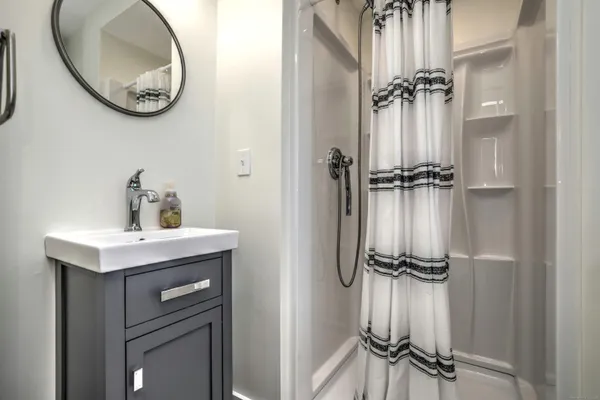 a bathroom with a light fixture and a mirror