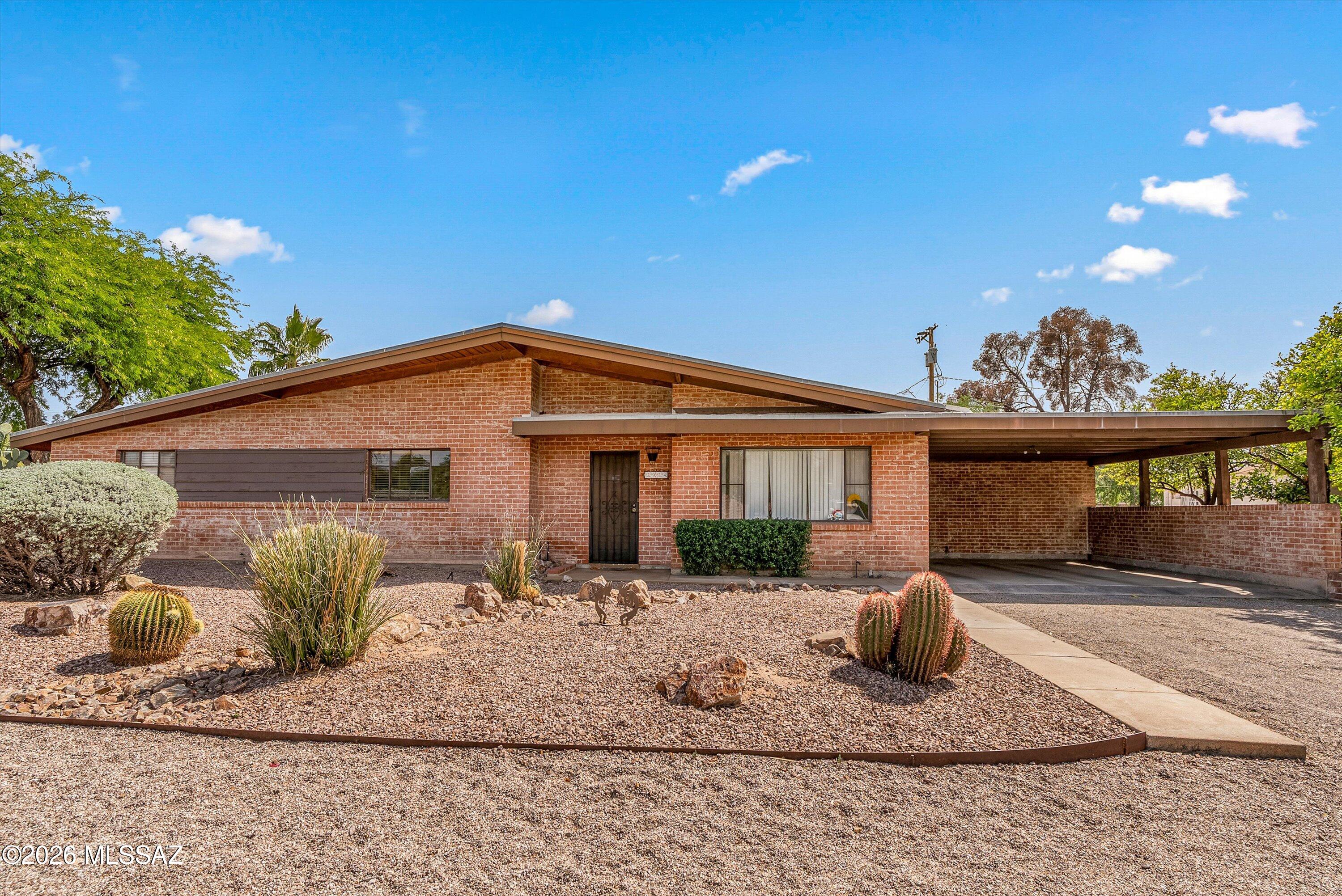 2934 East Exeter Street Tucson, AZ 85716 - Photo 1 of 20 a front view of a house with garden