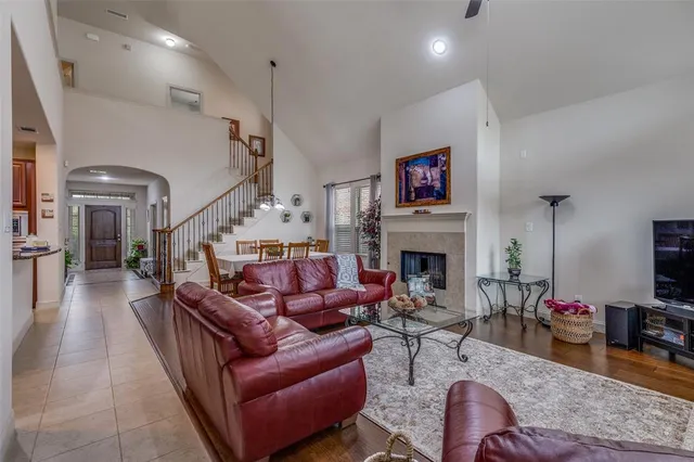 a living room with furniture a fireplace and a flat screen tv