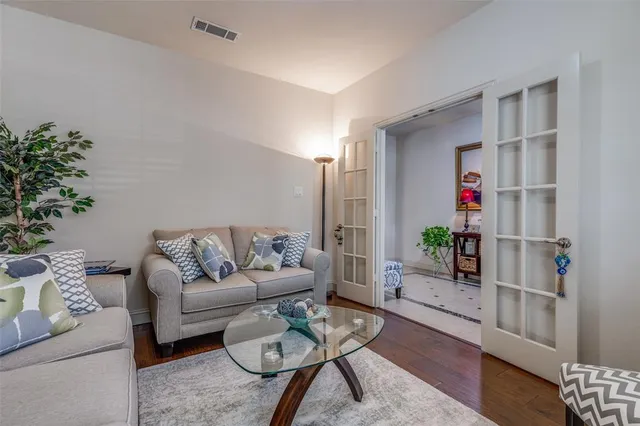 a living room with furniture and flowers