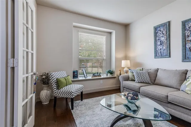 a living room with furniture and a floor to ceiling window